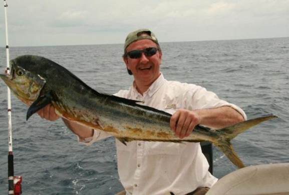 A person holding a fish

Description automatically generated